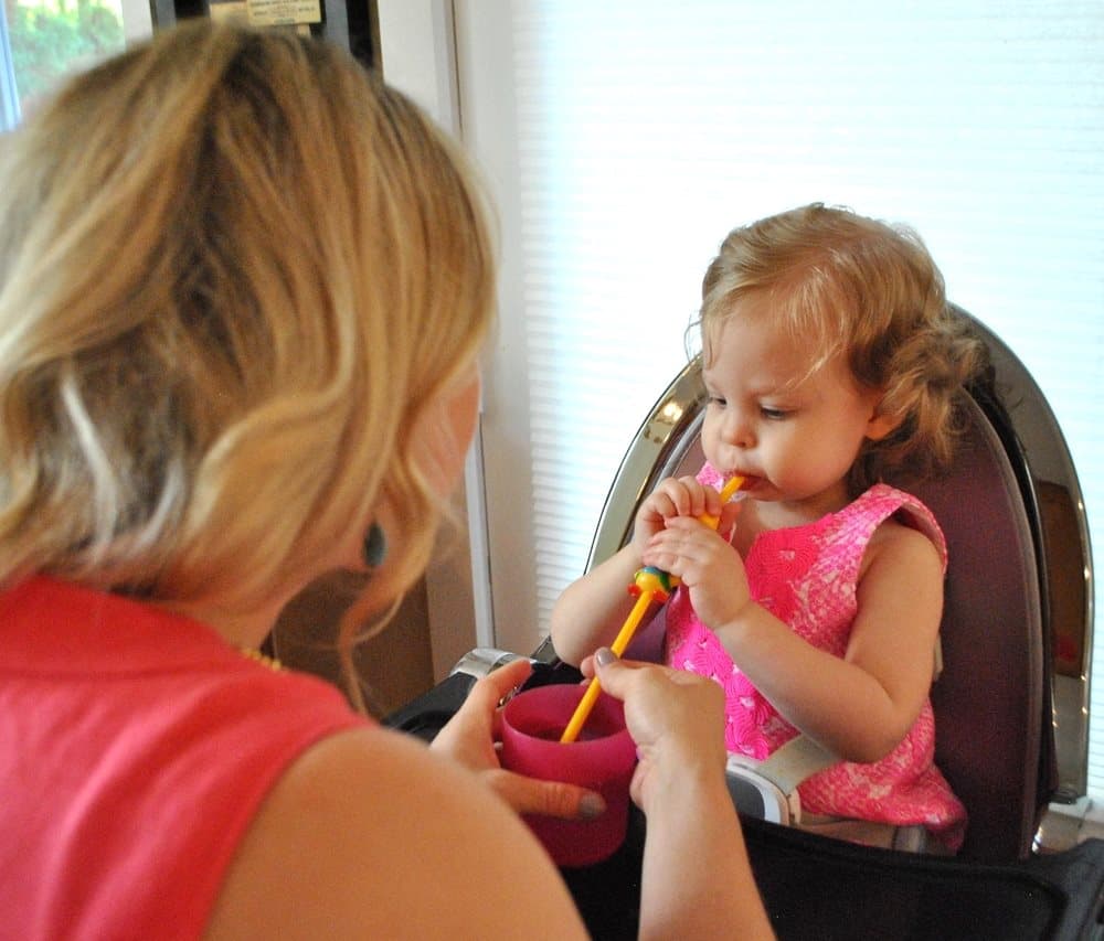 Laura Friedman working with a toddler on oral motor feeding exercises using straw techniques