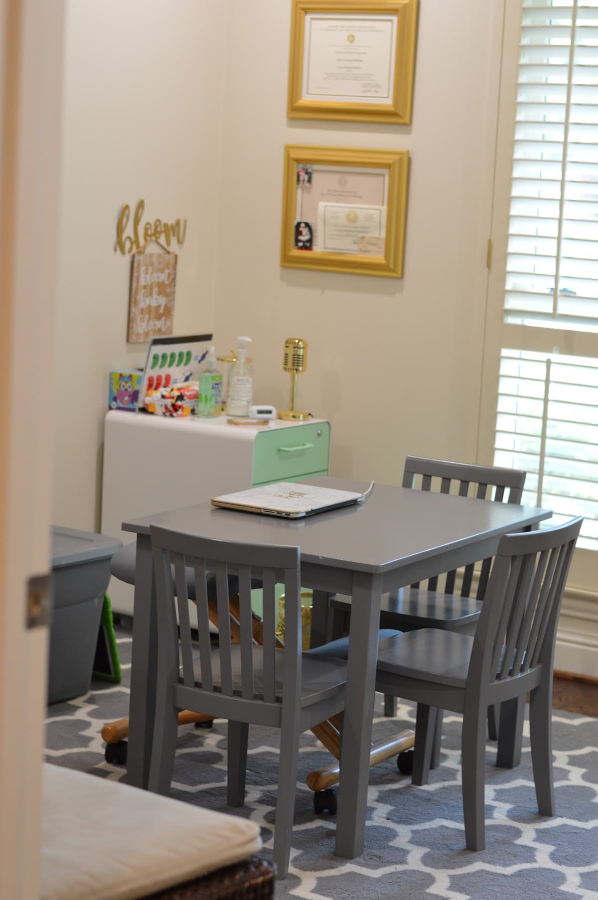 Bloom Myofunctional & Speech Therapy room with child-sized table, therapy materials, and professional credentials